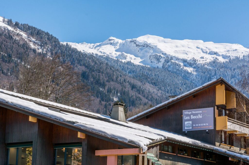 Chalet avec sommets enneigés en arrière-plan